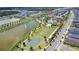 An aerial view of a community with a basketball court, a pond, and lush landscaping at 1567 Carey Palm Cir, Kissimmee, FL 34747