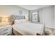 Elegant bedroom with a gray tufted headboard and soft lighting at 1567 Carey Palm Cir, Kissimmee, FL 34747
