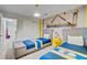 Playful bedroom featuring two twin beds and colorful Minions wall mural at 1567 Carey Palm Cir, Kissimmee, FL 34747