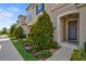 Front exterior of a townhome with landscaping, pathway, and entry door at 1567 Carey Palm Cir, Kissimmee, FL 34747