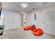 Game room area with beanbag chairs, a TV, and access to other rooms at 1567 Carey Palm Cir, Kissimmee, FL 34747