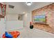 Fun game room with a TV, beanbag chairs, and brick accent wall at 1567 Carey Palm Cir, Kissimmee, FL 34747