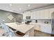 Modern kitchen with white cabinets, stainless steel appliances, and an island with seating at 1567 Carey Palm Cir, Kissimmee, FL 34747