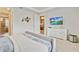 Primary bedroom featuring a large bed, TV, and attached bathroom access at 1567 Carey Palm Cir, Kissimmee, FL 34747