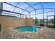 Private screened-in pool with paver deck, offering a serene and refreshing backyard oasis at 1567 Carey Palm Cir, Kissimmee, FL 34747