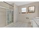 Bathroom with decorative sliding glass shower door, vanity, and tiled floors at 2124 Cassingham Cir, Ocoee, FL 34761