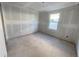 Empty bedroom with drywall, a window, and flooring at 2372 Broadbrook Dr, Saint Cloud, FL 34771