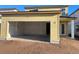 Exterior view of a house with an open garage and yellow siding at 2372 Broadbrook Dr, Saint Cloud, FL 34771