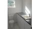 Modern bathroom with white vanity, dark countertop, and contemporary fixtures at 2449 Sunset Dr, Lake Wales, FL 33898