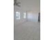 Spacious living area with white walls, tile flooring, and large windows at 2449 Sunset Dr, Lake Wales, FL 33898