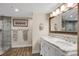 Modern bathroom with a walk-in shower, double vanity, and marble countertop at 2967 S Atlantic Ave # 504, Daytona Beach Shores, FL 32118