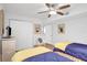 Charming bedroom featuring two twin beds, a ceiling fan, and beach-themed artwork at 2967 S Atlantic Ave # 504, Daytona Beach Shores, FL 32118