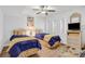 Cozy bedroom with two twin beds, ceiling fan, and beach-themed decor at 2967 S Atlantic Ave # 504, Daytona Beach Shores, FL 32118