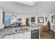 Kitchen with granite countertops, stainless steel sink, and view of the dining area at 2967 S Atlantic Ave # 504, Daytona Beach Shores, FL 32118