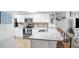 Modern kitchen with white cabinets, granite counters, and stainless steel appliances at 2967 S Atlantic Ave # 504, Daytona Beach Shores, FL 32118