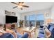 Living room with blue couches, ocean view, and sliding glass doors leading to a balcony at 2967 S Atlantic Ave # 504, Daytona Beach Shores, FL 32118