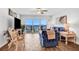 Living room with blue couch, ocean view, and sliding glass doors to balcony at 2967 S Atlantic Ave # 504, Daytona Beach Shores, FL 32118
