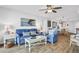 Blue couch, wicker chairs, and ocean view in living room at 2967 S Atlantic Ave # 504, Daytona Beach Shores, FL 32118