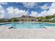 Inviting community pool with a paved deck and shaded pavilion at 3541 Sandalwood Isle Way, Ocoee, FL 34761