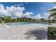 Inviting community pool with palm trees, lush landscaping, and brick pavers at 3541 Sandalwood Isle Way, Ocoee, FL 34761