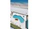 Aerial view of the pool, hot tub, lounge chairs, and beach at 3647 S Atlantic Ave # 701, Daytona Beach Shores, FL 32118