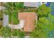 Top-down view of a house with a driveway and surrounded by trees and a nearby lake at 3966 Lake Mira Dr, Orlando, FL 32817