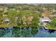Lakefront home with a pool, dock, and lush landscaping at 3966 Lake Mira Dr, Orlando, FL 32817