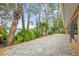 Paved patio and lush landscaping along the shore of a serene lake at 3966 Lake Mira Dr, Orlando, FL 32817