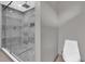 Modern bathroom showcasing a glass shower with a pebble floor and a toilet at 3966 Lake Mira Dr, Orlando, FL 32817