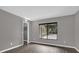 Gray bedroom with wood-look flooring, a large window, and a closet door at 3966 Lake Mira Dr, Orlando, FL 32817