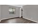 Simple bedroom with gray walls, wood-look flooring, and a window at 3966 Lake Mira Dr, Orlando, FL 32817