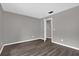 Empty bedroom with gray walls, wood-look floors, and an open doorway at 3966 Lake Mira Dr, Orlando, FL 32817