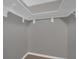 Walk-in closet with white shelving and gray walls, ready for storage at 3966 Lake Mira Dr, Orlando, FL 32817