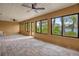 Florida room with tile floor, large windows, ceiling fans, and lake view at 3966 Lake Mira Dr, Orlando, FL 32817