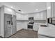 Modern kitchen with white shaker cabinets, stainless steel appliances, and quartz countertops at 3966 Lake Mira Dr, Orlando, FL 32817