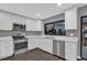 Kitchen with stainless steel appliances, quartz countertops, and updated fixtures at 3966 Lake Mira Dr, Orlando, FL 32817