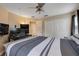 Main bedroom with large bed, built-in desk and en-suite bathroom at 402 Reed Grass Dr, Oviedo, FL 32765