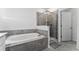 Modern bathroom featuring a soaking tub, glass shower, and tiled walls at 438 Bogey Dr, Davenport, FL 33896