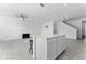 View of the kitchen island and living room, featuring white cabinetry and tile flooring at 438 Bogey Dr, Davenport, FL 33896