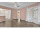 Cozy bedroom with wood-look flooring, ceiling fan, and French doors leading to a private space at 4402 Middlebrook Rd # 4, Orlando, FL 32811