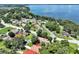 High-angle aerial view of a property near a lake with surrounding houses at 5 Forest Ln, Eustis, FL 32726