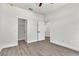 Simple bedroom with wood-look tile floors, ceiling fan and closet at 5 Forest Ln, Eustis, FL 32726