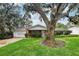 Quaint single-story home nestled amongst mature trees and lush green grass at 5024 Saint Germain Ave, Belle Isle, FL 32812