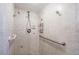 Bathroom with shower, grab bars, and tiled walls at 532 Maricopa Dr, Kissimmee, FL 34758