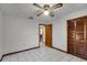 Second bedroom with double door closet and ceiling fan at 532 Maricopa Dr, Kissimmee, FL 34758