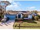 Single story home with blue garage door and neatly landscaped yard at 532 Maricopa Dr, Kissimmee, FL 34758