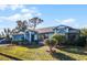 Single-story house with blue accents, a two-car garage, and a well-manicured lawn at 532 Maricopa Dr, Kissimmee, FL 34758
