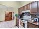 Kitchen with wood cabinets, granite countertops, and a glass top stove at 532 Maricopa Dr, Kissimmee, FL 34758