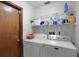 Laundry room with washer, dryer, and shelving at 532 Maricopa Dr, Kissimmee, FL 34758