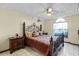 Main bedroom with a large bed, nightstands and ceiling fan at 532 Maricopa Dr, Kissimmee, FL 34758
